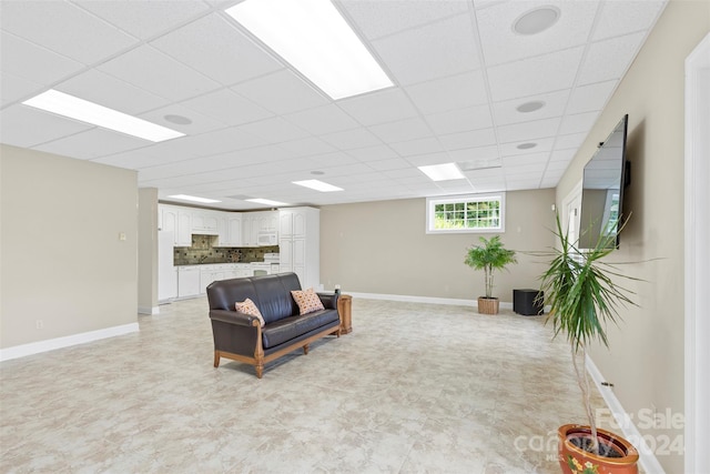 living room featuring a drop ceiling