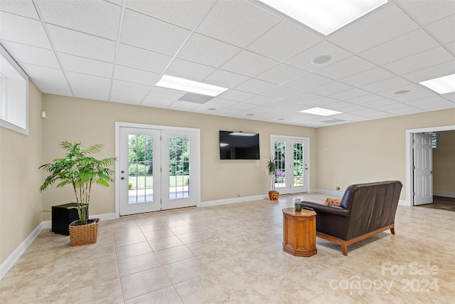 living room with french doors and a paneled ceiling