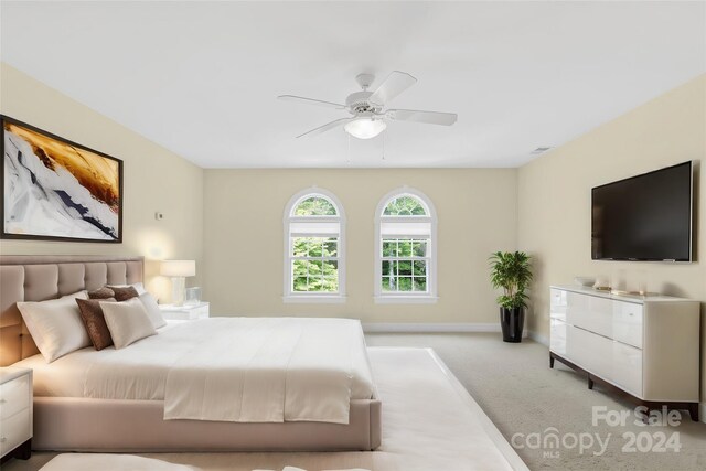 bedroom featuring light carpet and ceiling fan