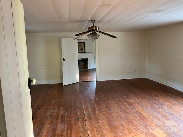 spare room with ceiling fan and dark hardwood / wood-style flooring