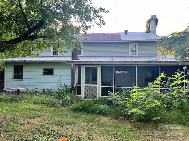 back of house with a sunroom