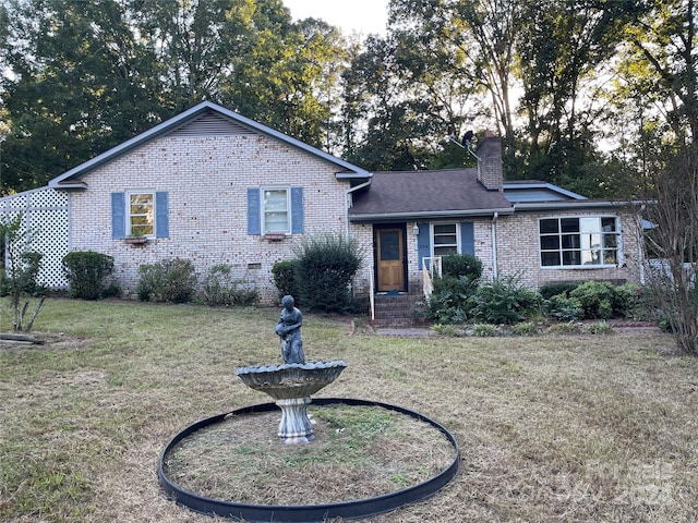 ranch-style house featuring a front lawn