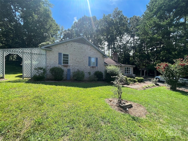 view of property exterior with a yard