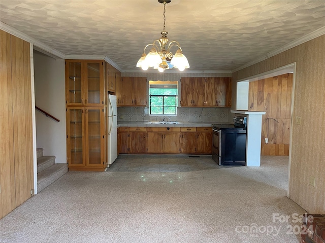 kitchen featuring decorative light fixtures, sink, ornamental molding, white fridge, and stainless steel electric range