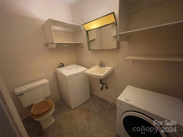 bathroom with washer / clothes dryer, sink, and toilet