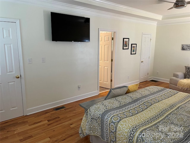 bedroom featuring ceiling fan, wood-type flooring, and ornamental molding