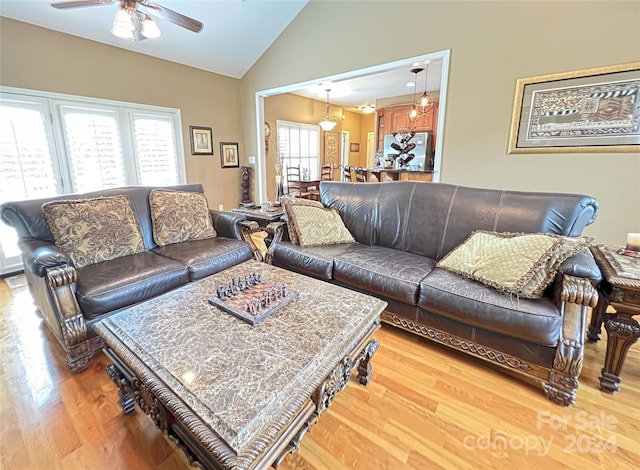 living room with hardwood / wood-style flooring, a healthy amount of sunlight, ceiling fan, and vaulted ceiling