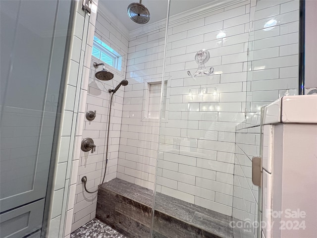 bathroom featuring ornamental molding and a shower with shower door