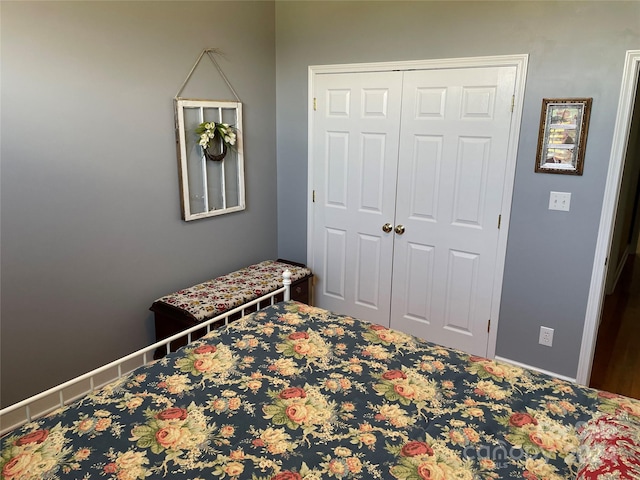 bedroom with a closet and baseboards