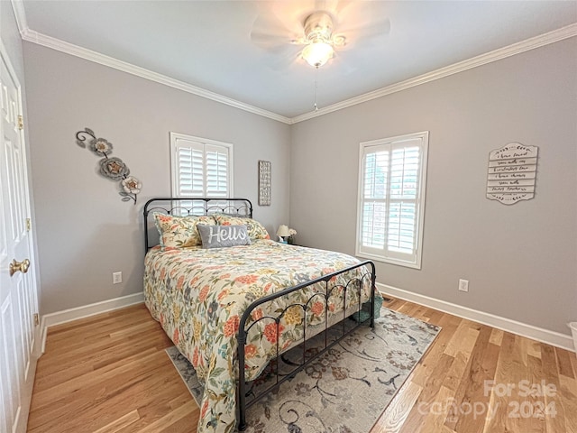 bedroom featuring light wood-type flooring, baseboards, ornamental molding, and ceiling fan