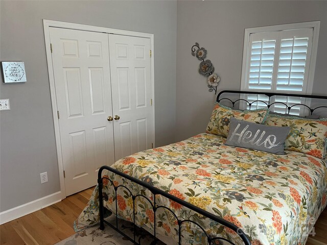 bedroom featuring hardwood / wood-style floors and a closet