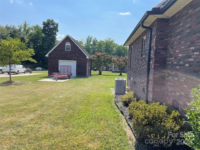 view of yard with central air condition unit and a detached garage