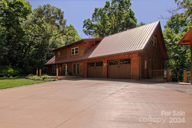 cabin with covered porch and a garage