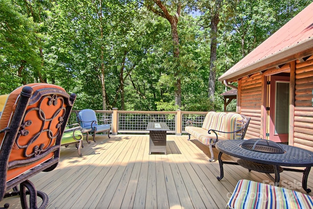 wooden terrace featuring an outdoor fire pit