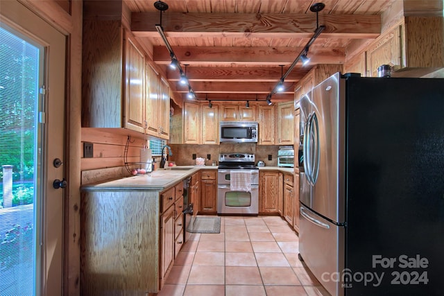 kitchen with pendant lighting, light tile patterned flooring, sink, and appliances with stainless steel finishes