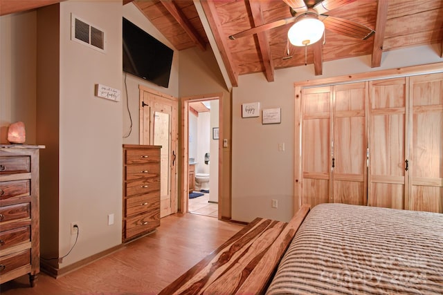 bedroom with ceiling fan, vaulted ceiling with beams, light hardwood / wood-style flooring, ensuite bathroom, and wood ceiling