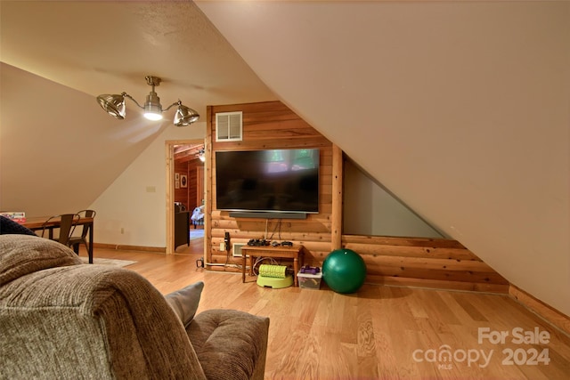 living room with wood-type flooring and lofted ceiling