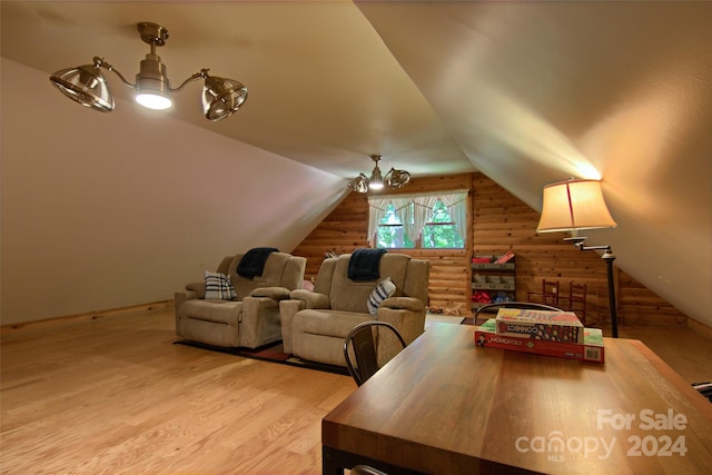 cinema room with vaulted ceiling and light wood-type flooring