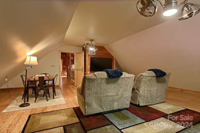 living room with hardwood / wood-style floors and lofted ceiling