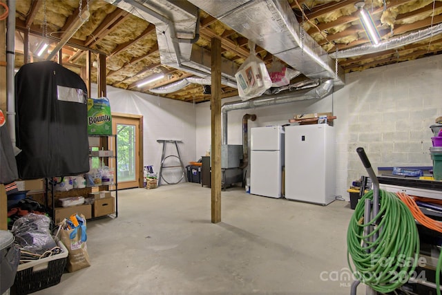 basement featuring white fridge