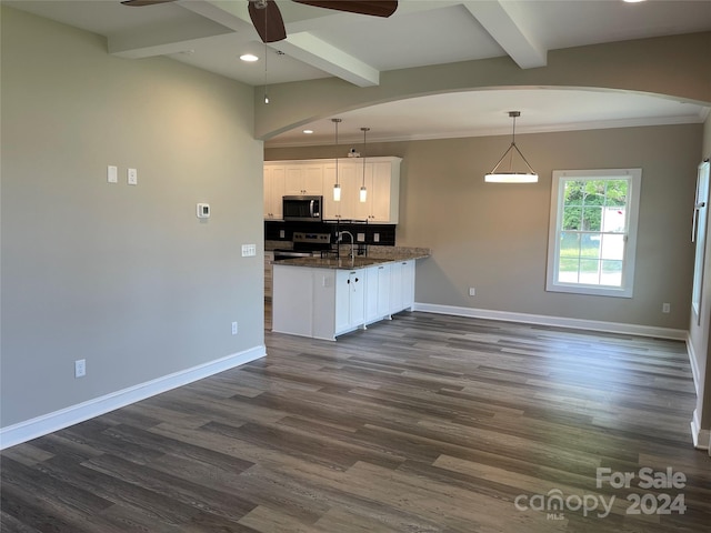 kitchen featuring pendant lighting, white cabinetry, dark hardwood / wood-style floors, beamed ceiling, and stainless steel appliances