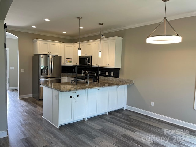 kitchen featuring white cabinets, decorative light fixtures, and appliances with stainless steel finishes