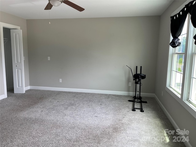 exercise room with ceiling fan