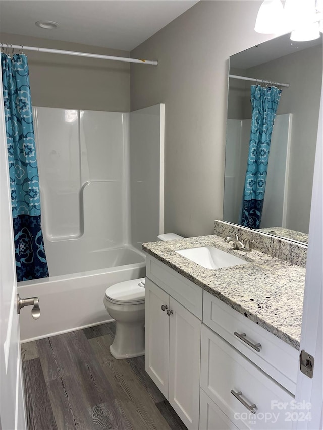 full bathroom featuring vanity, toilet, shower / bath combination with curtain, and hardwood / wood-style floors