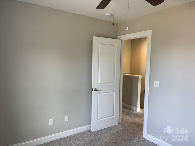 unfurnished bedroom featuring ceiling fan and carpet flooring