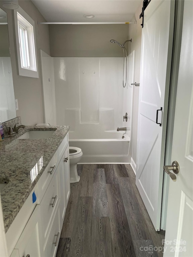 full bathroom with vanity, toilet, hardwood / wood-style floors, and shower / bathing tub combination