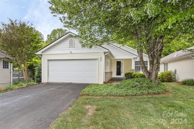 single story home with a garage and a front lawn