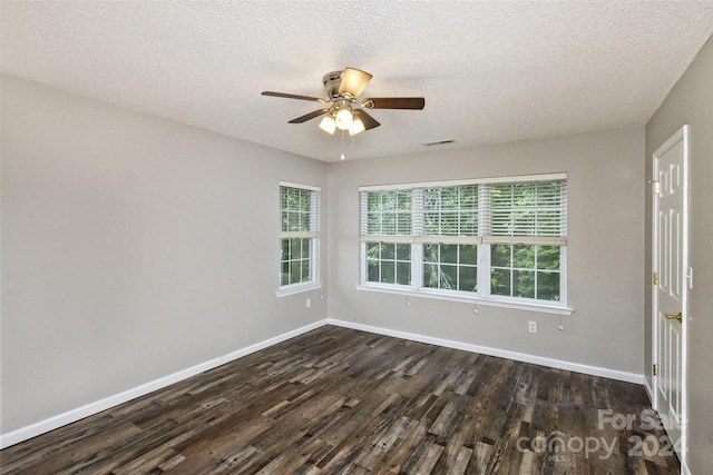 unfurnished room featuring a textured ceiling, ceiling fan, and dark wood-type flooring