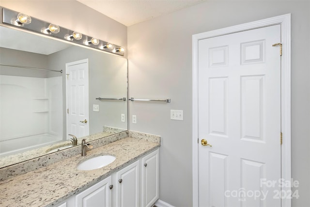 bathroom with vanity and walk in shower