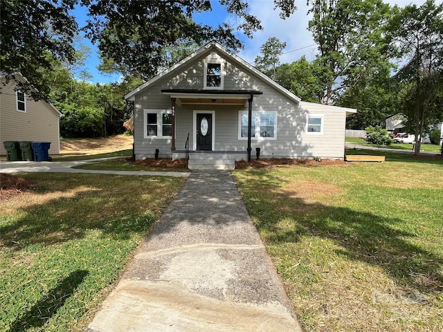 bungalow-style house with covered porch and a front yard