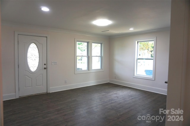 foyer with dark hardwood / wood-style flooring and crown molding