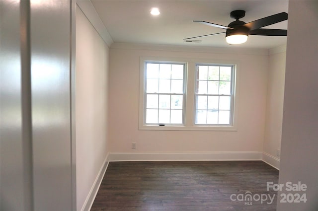 spare room featuring ceiling fan, ornamental molding, and dark hardwood / wood-style flooring