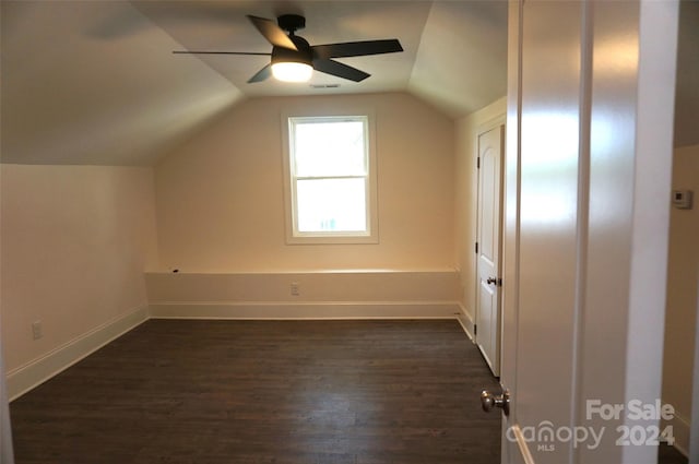 additional living space with ceiling fan, dark wood-type flooring, and vaulted ceiling