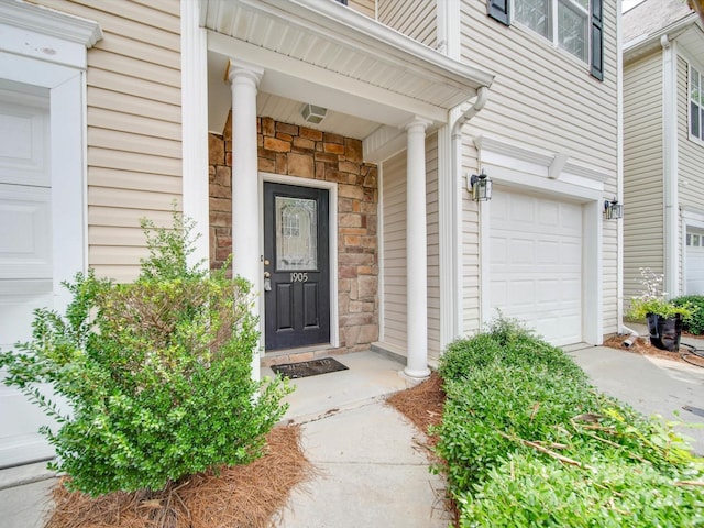 view of exterior entry with a garage