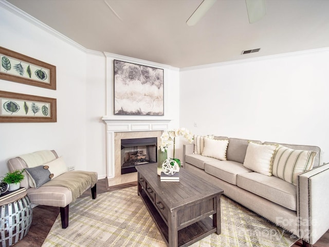 living room featuring a fireplace and crown molding