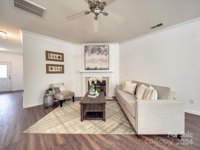 living room featuring ceiling fan, crown molding, and wood-type flooring