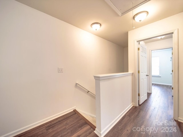 hallway with dark hardwood / wood-style flooring