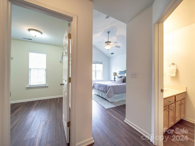 corridor featuring dark hardwood / wood-style floors and lofted ceiling