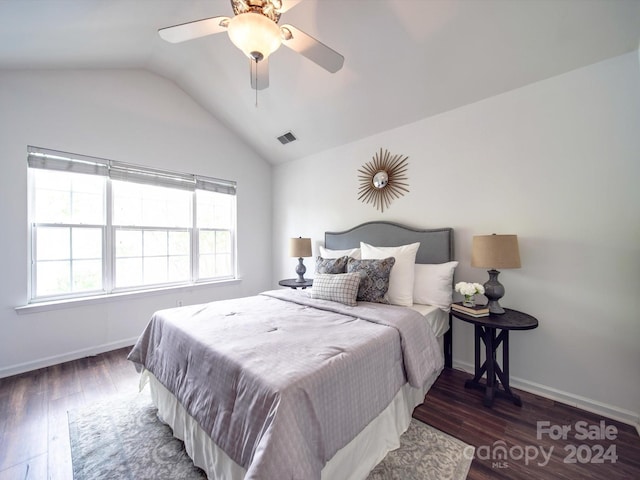 bedroom with ceiling fan, dark wood-type flooring, and vaulted ceiling