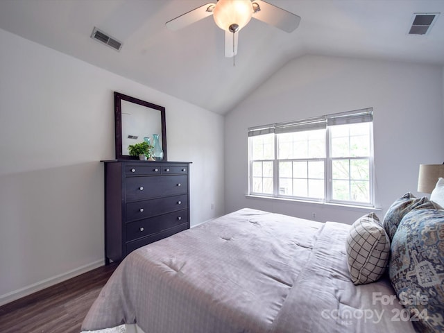 bedroom featuring ceiling fan, dark hardwood / wood-style flooring, and vaulted ceiling