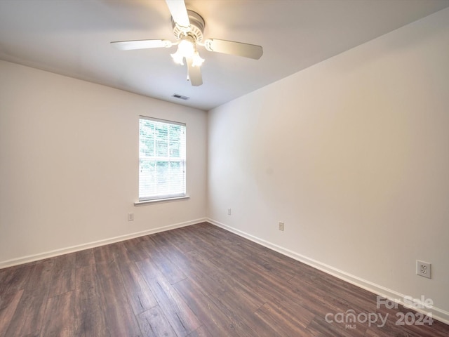 unfurnished room featuring dark hardwood / wood-style floors and ceiling fan