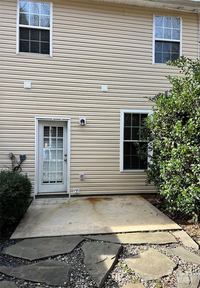 entrance to property with a patio area