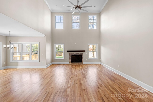 unfurnished living room with ornamental molding, light wood-type flooring, and a healthy amount of sunlight