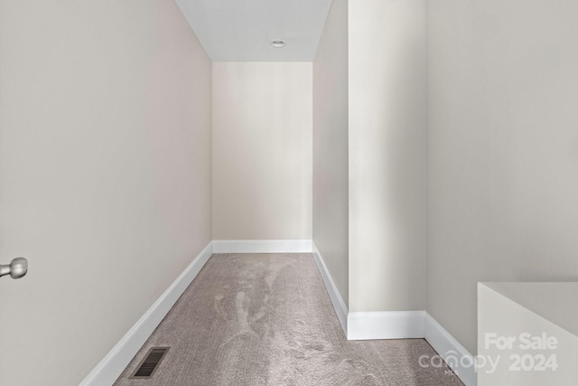 interior space with carpet floors and baseboards