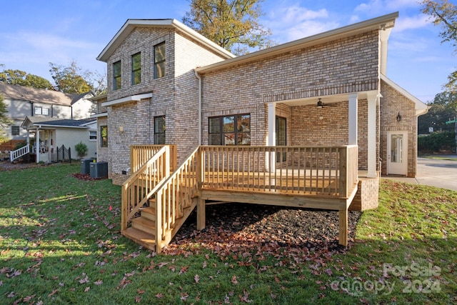 back of house featuring a lawn, a wooden deck, ceiling fan, and central AC unit