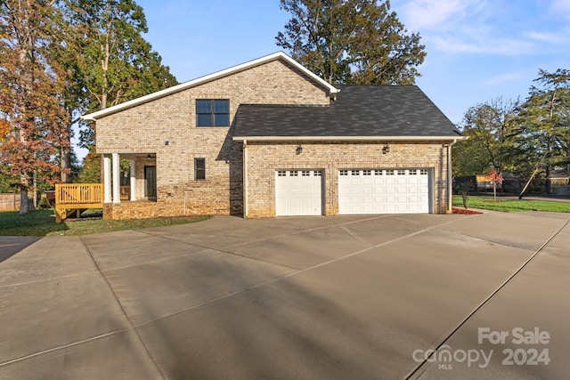 view of front of property with a garage and a wooden deck